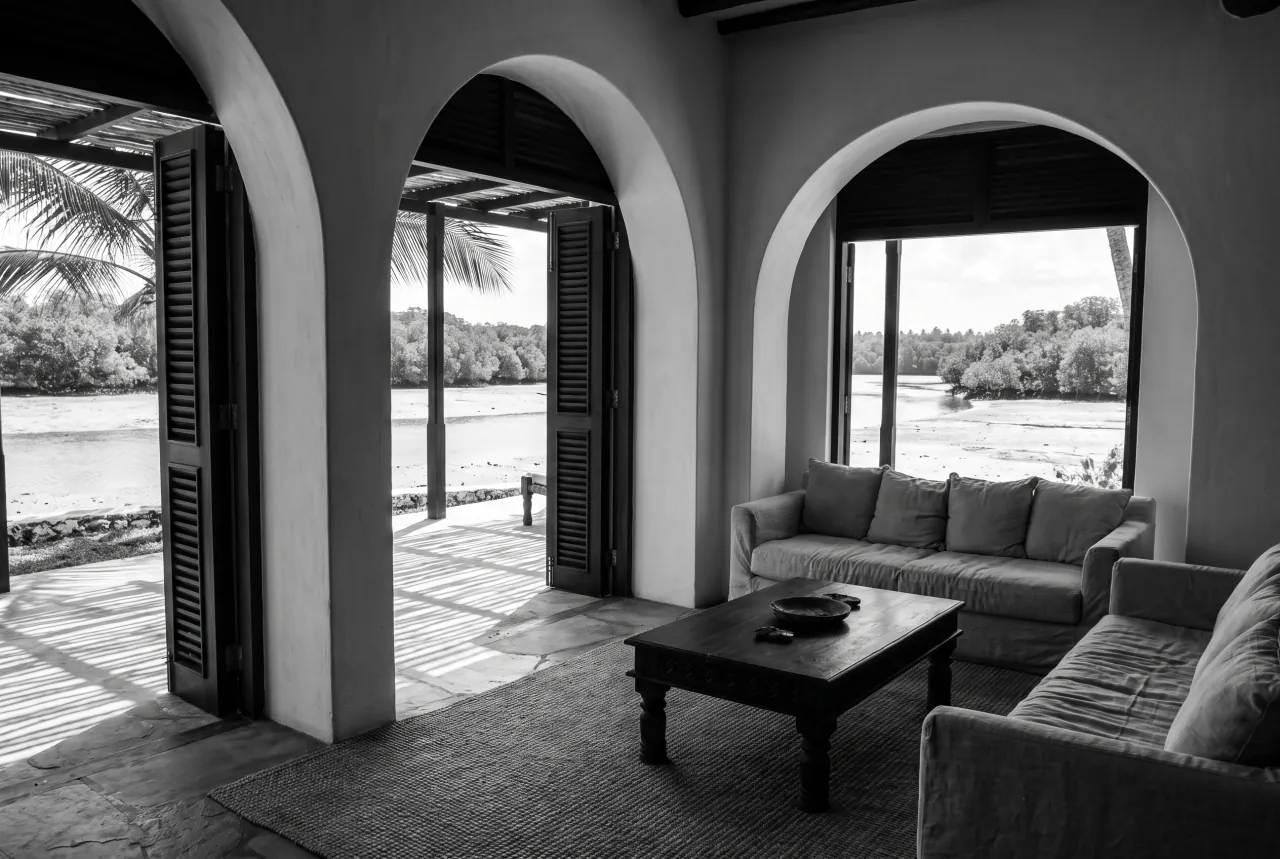 Creek Suite at Black Groove Lounge — living room with arched openings and a veranda over Kilifi Creek, black and white photograph