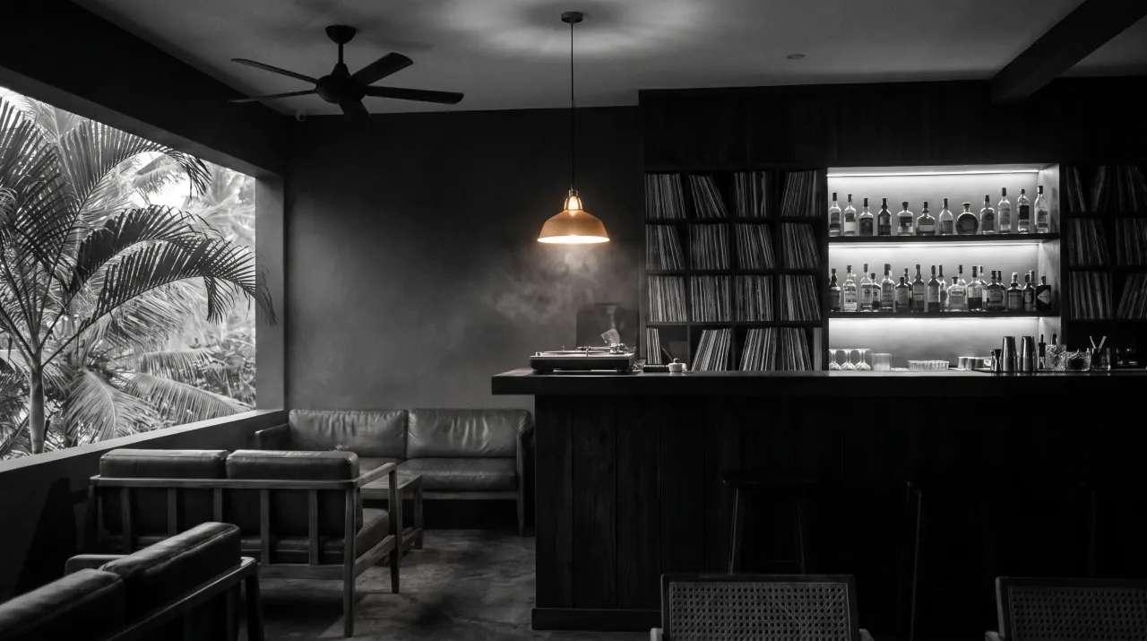 The record bar at Black Groove Lounge — dark timber counter, turntable and a wall of vinyl